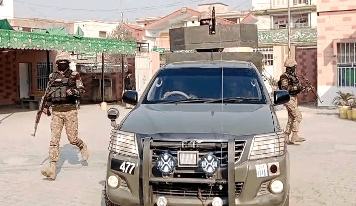 A security vehicle at the site of Chodwan police station in Dera Ismail Khan after it was attacked on Monday.